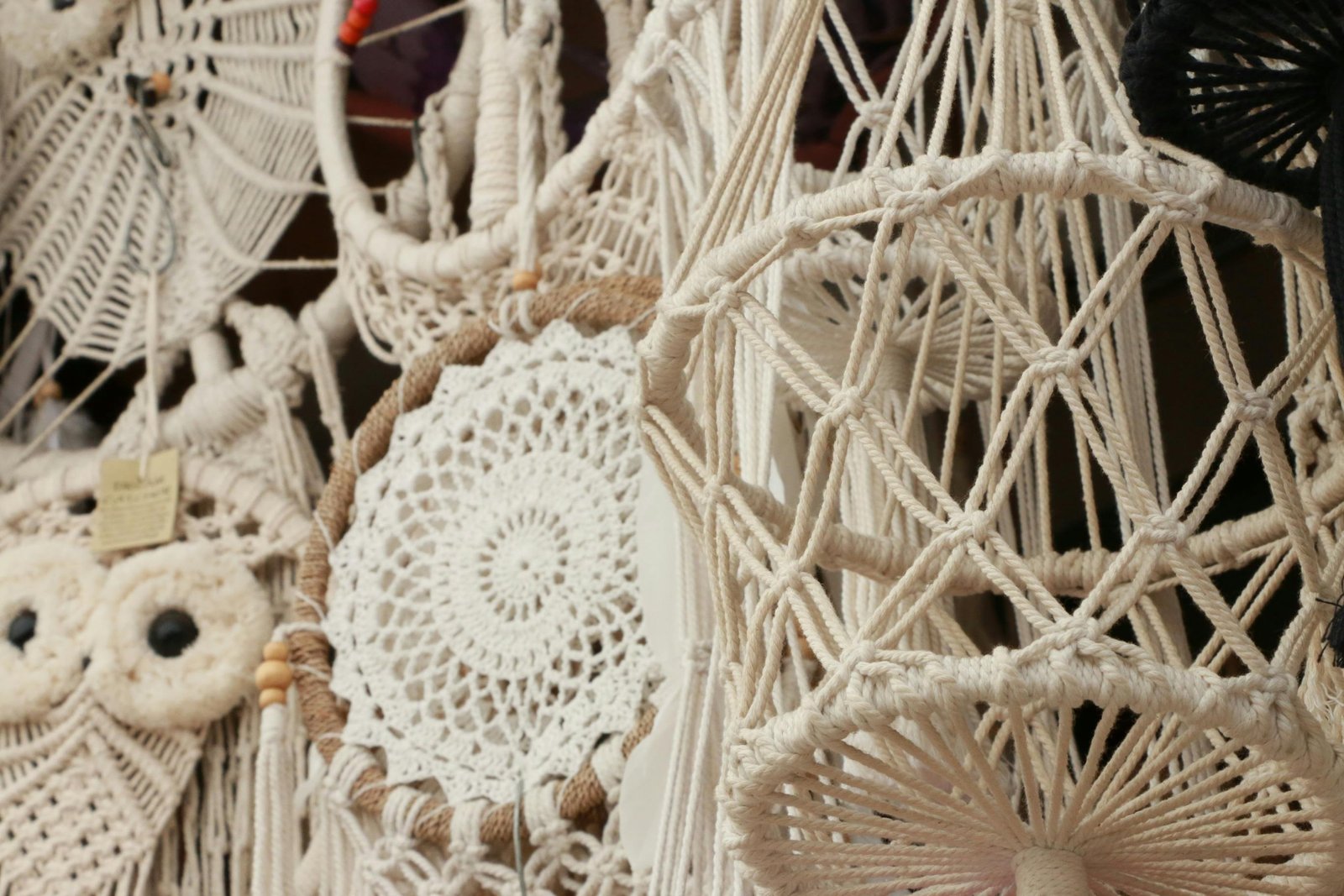 Detailed close-up of intricate boho macrame art with varied patterns and hanging designs.